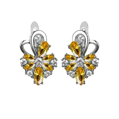 Boucles d'oreilles en zircon en forme de goutte avec pierres jaunes et blanches en forme de fleur.