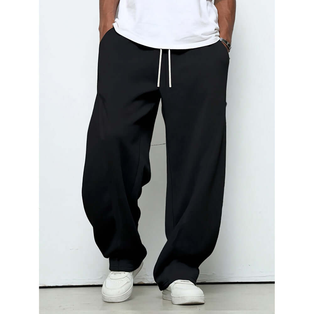 Pantalons baggy in black color with drawstring closure for adjustable comfort, designed for youth casual wear.