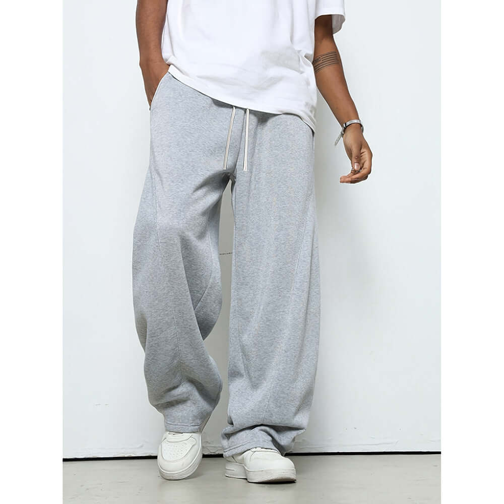Pantalons baggy gris avec taille mi-haute et fermeture à cordon pour un ajustement confortable.